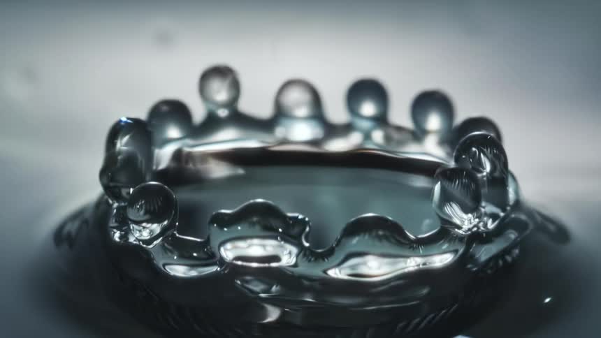 A water droplet splashing into a body of water