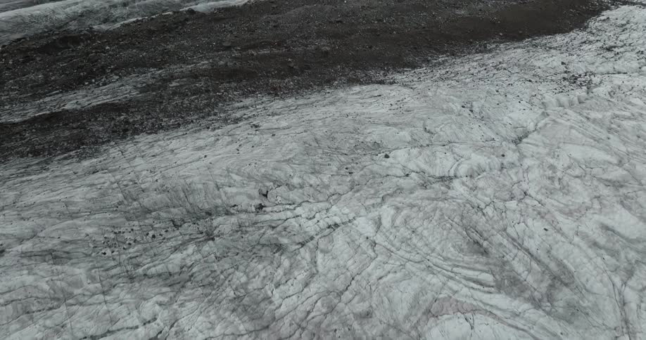 An aerial view of a snowy mountain landscape in winter