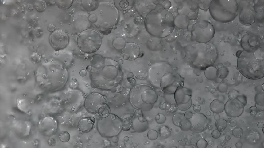 Bubbles move past a still camera