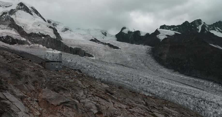 An aerial view of mountains with snow on them