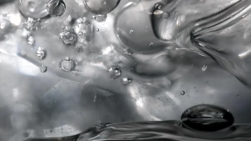 Light shines on bubbles in the water as they move