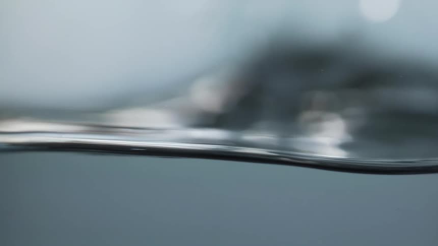 Close up view of water surface moving from partially underwater and partially above water