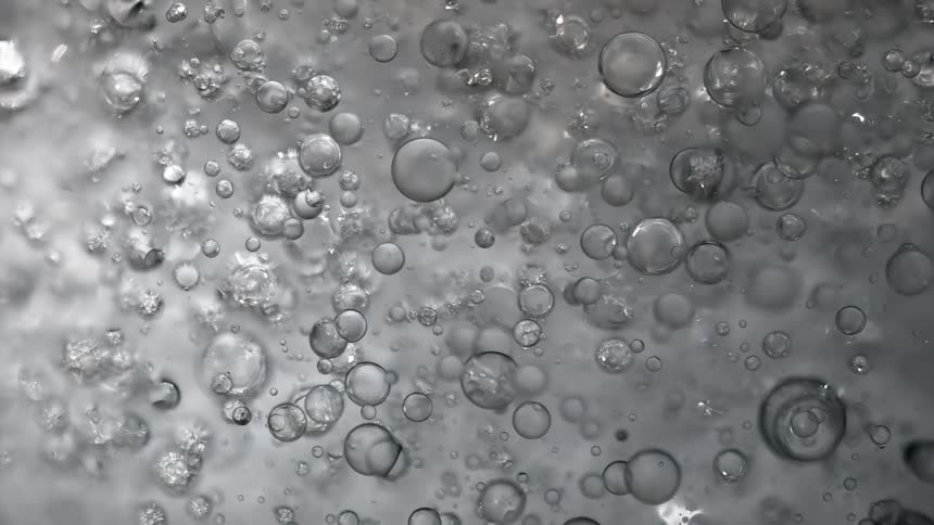 Bubble spheres are floating in a liquid and reflect light as they move