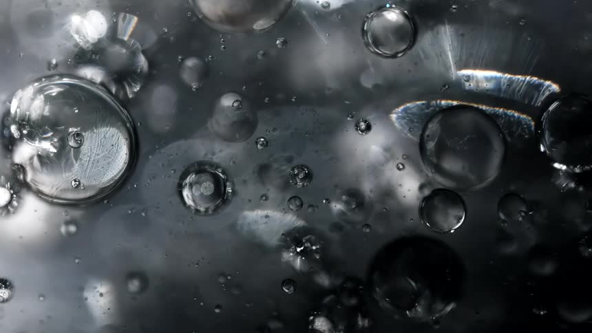Air bubbles form in a viscous clear liquid