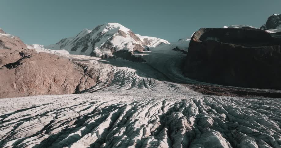 An aerial view of a mountain with snow on it