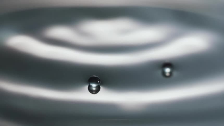 A drop of water falls and splashes
