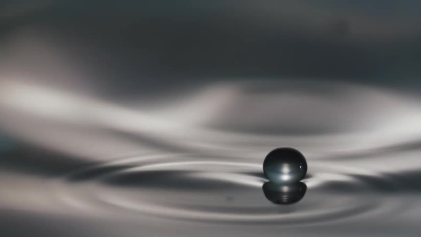 A droplet on the surface of rippling water