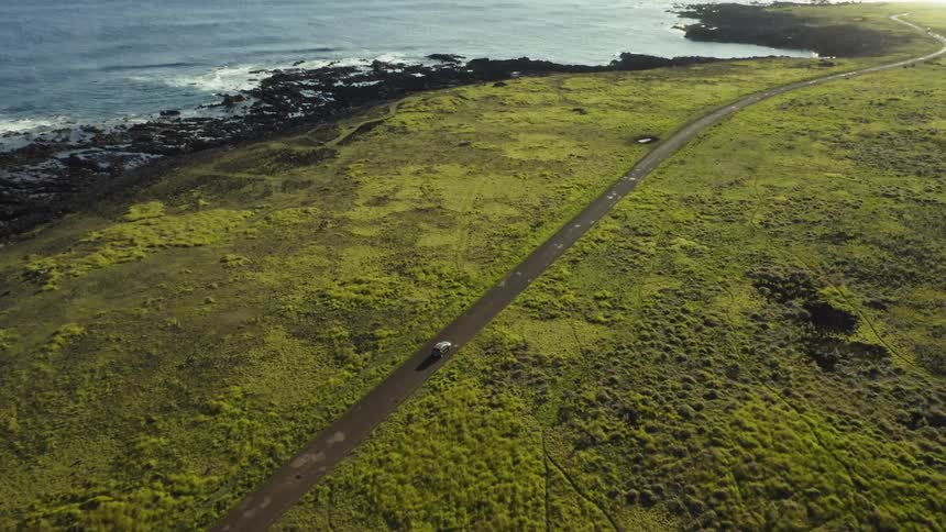 An aerial view of a car driving outdoors