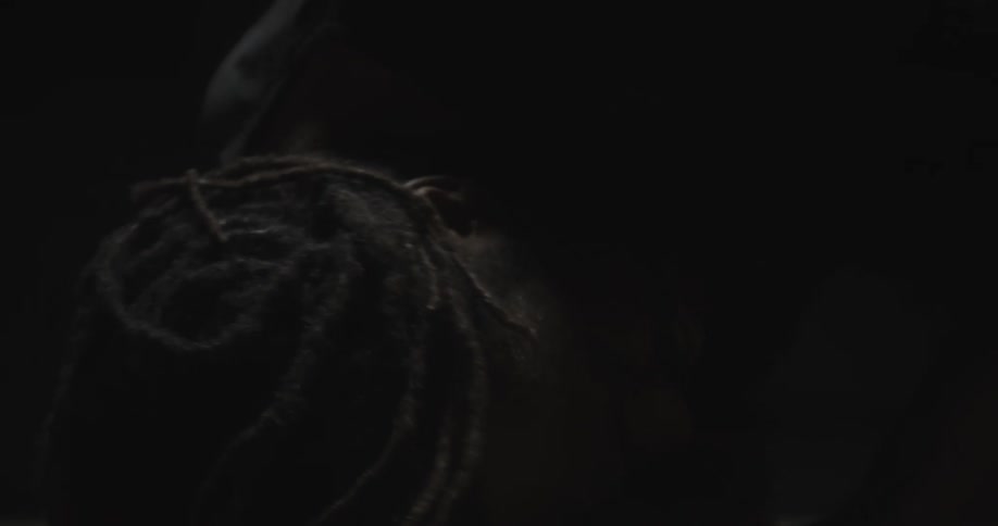 A man turning his head in darkness