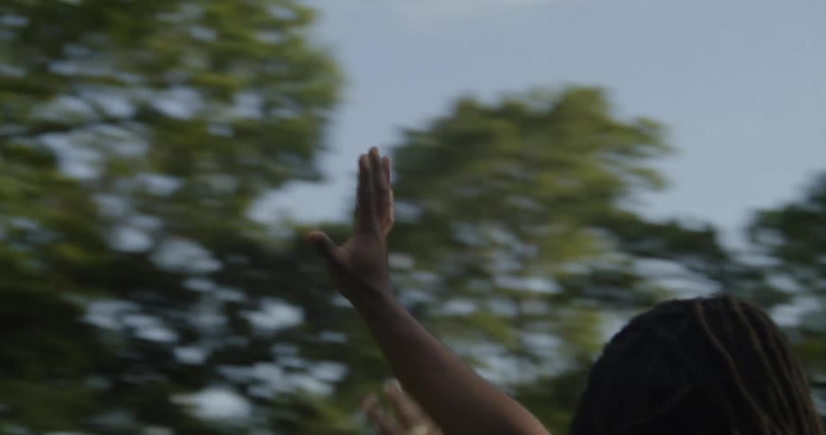 A man with his arms outstretched on a summer day