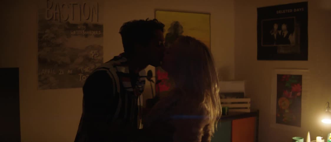 Man and woman entering room kiss and make out in bedroom