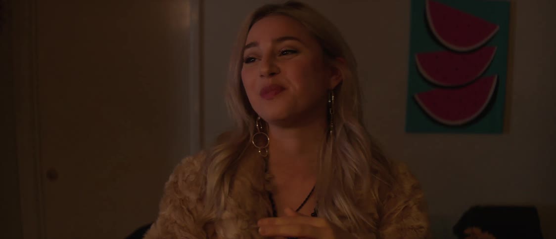 Awoman smiles as she puts a piece of food in her mouth