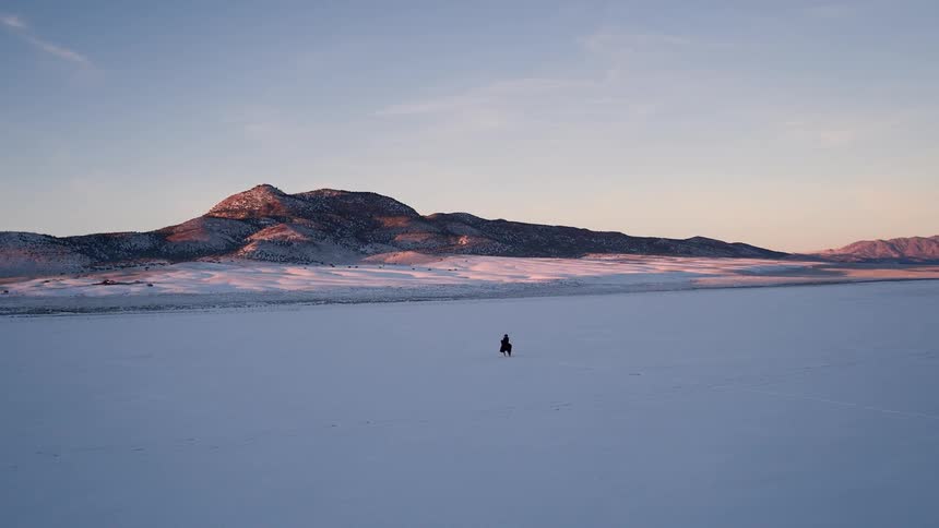 A man riding a horse through the snow