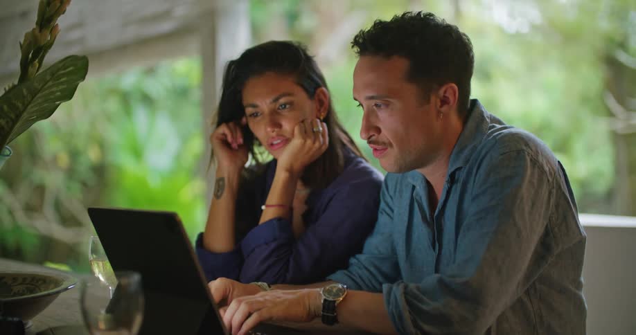 A couple are looking at a laptop together