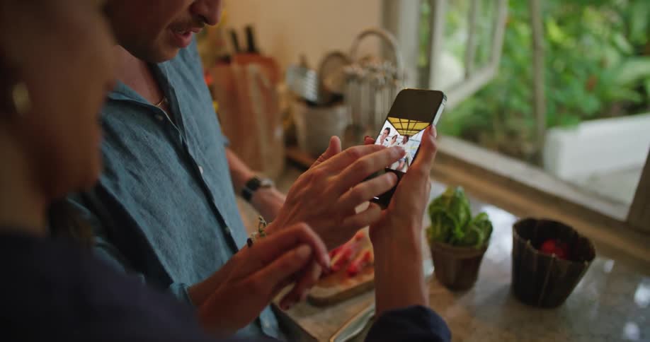 A couple look at a photo on a cell phone