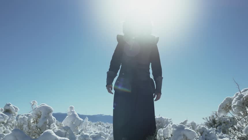 A man stands on a snow covered area