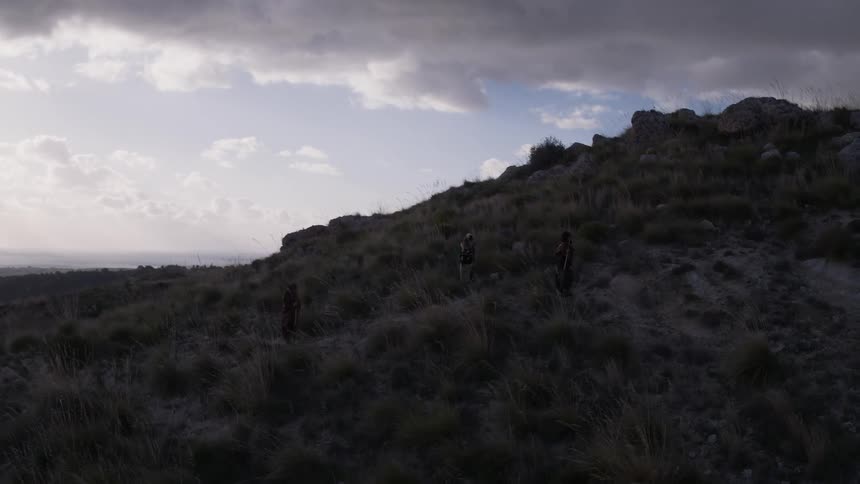 People are hiking on a hill