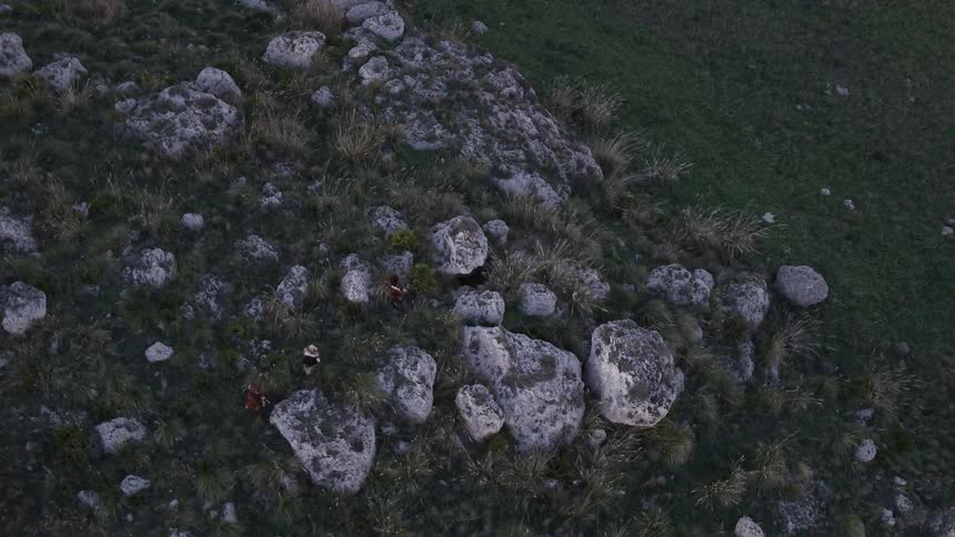 People are climbing over the rocks below