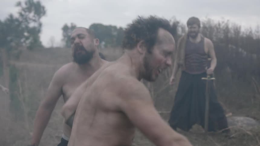 Two men fight as others watch
