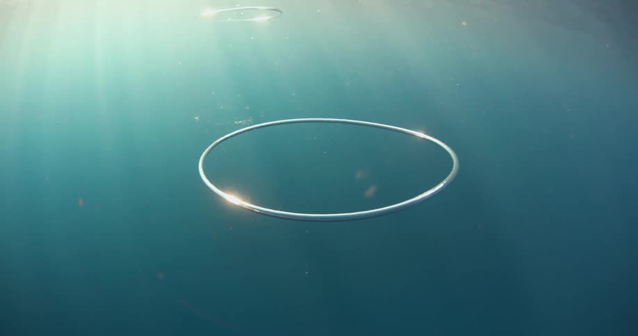 Silver hoops suspended underwater in the sea