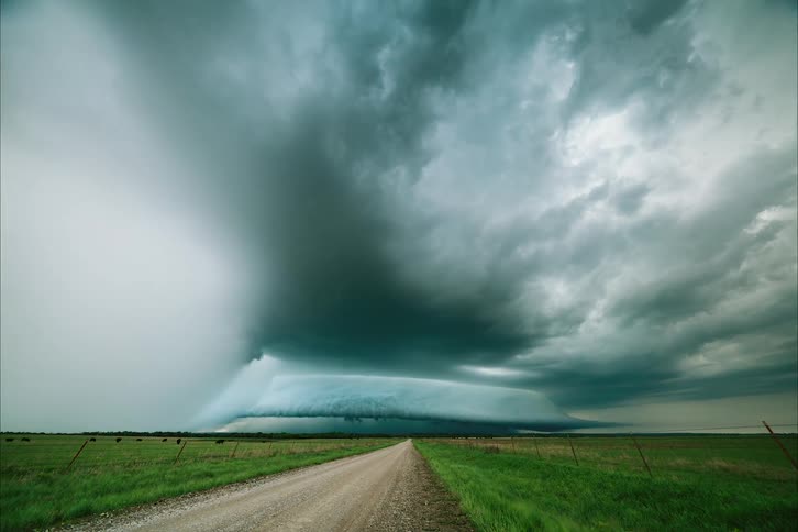 Time lapse of storm clouds moving over farmland with cattle