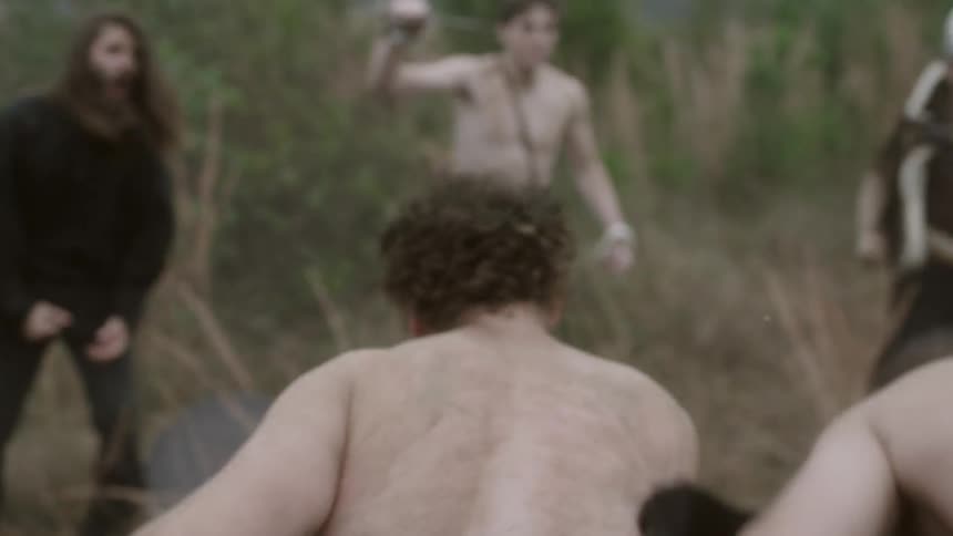 Two men fighting in the middle of a circle of cheering men
