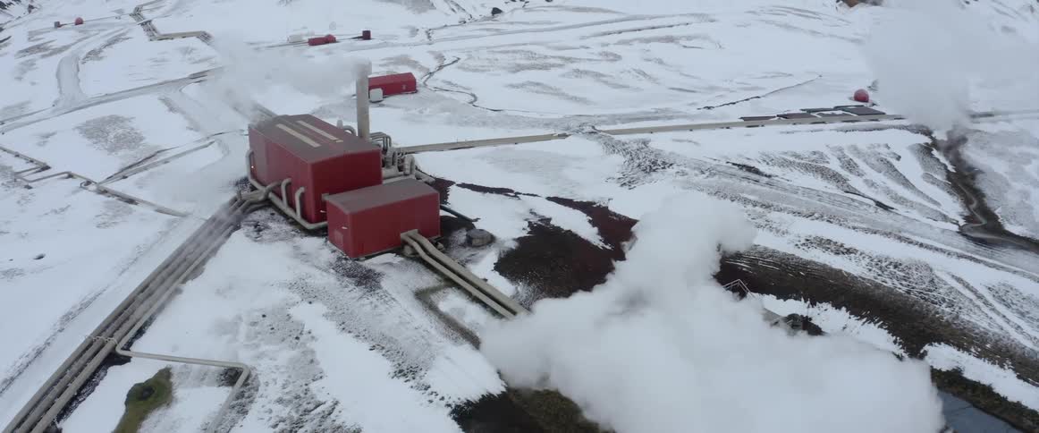 Aerial view of a geothermal energy power plant on the snow covered plains