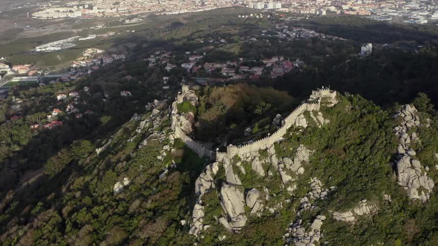 Camera slowly turns high above a mountain and a great wall