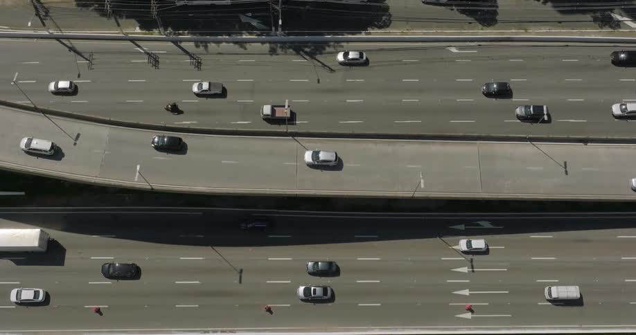Cars and trucks drive down a highway