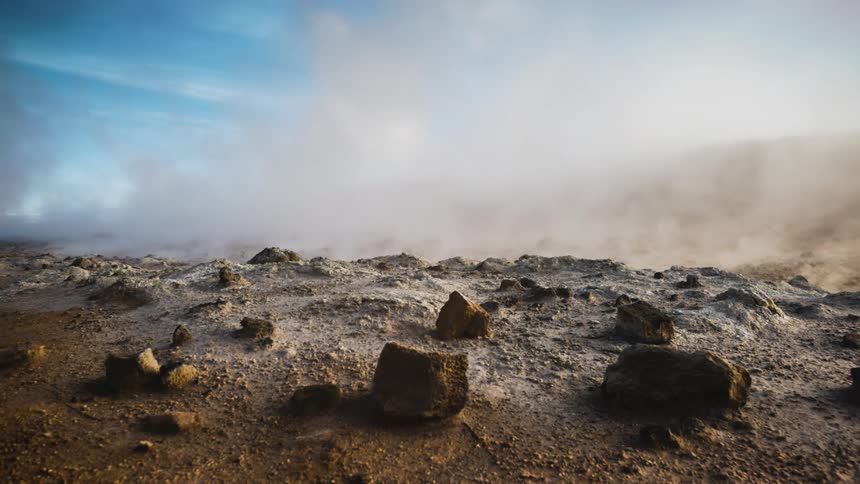 Steam rising from the ground on a rocky deserted area at daytime