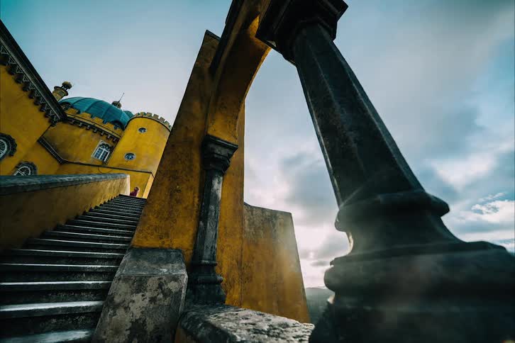 Time lapse of tourist climbing up and down the staircase outside a castle