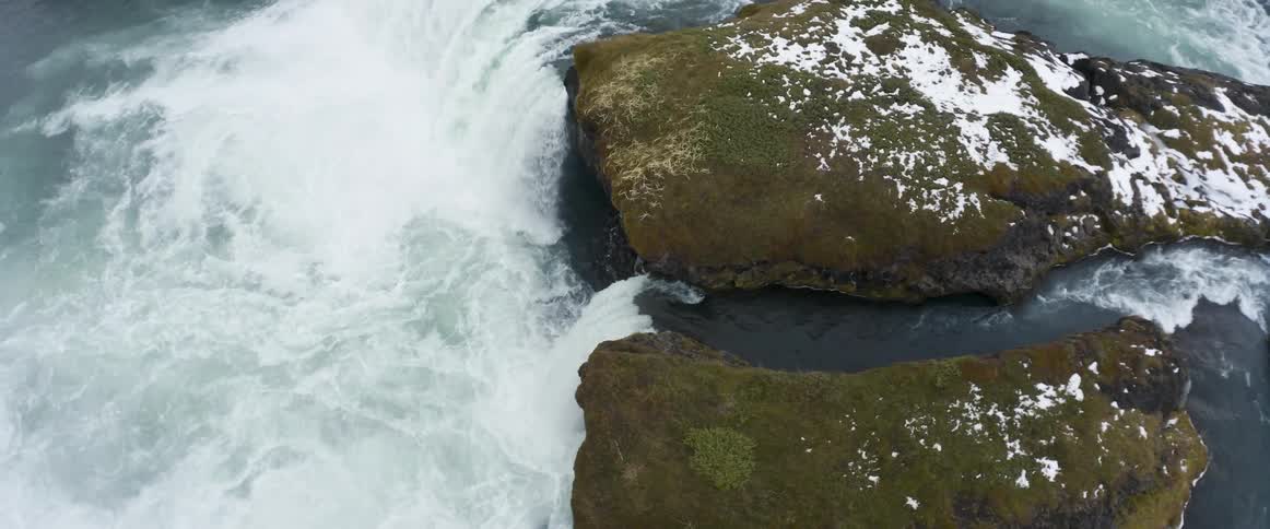 The water crashes below the waterfall