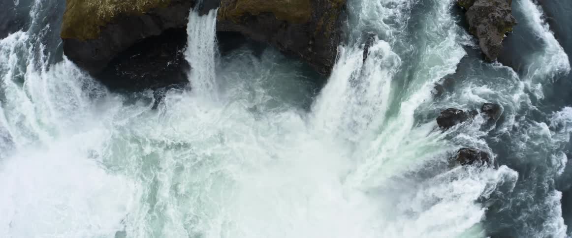 A large river splits up and falls over the cliff in different spots