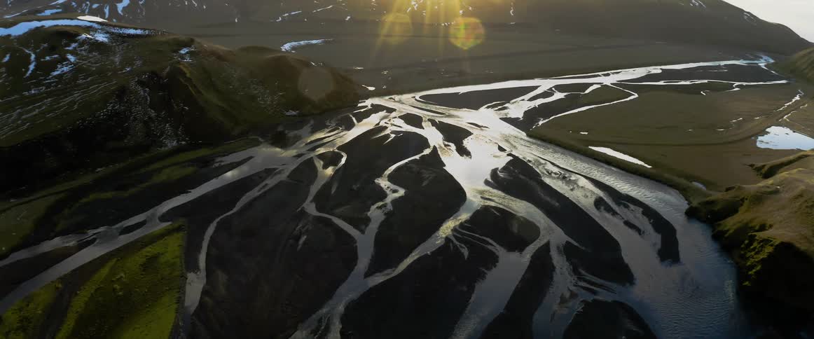 Multitude of streams pass mountains on a sunny day