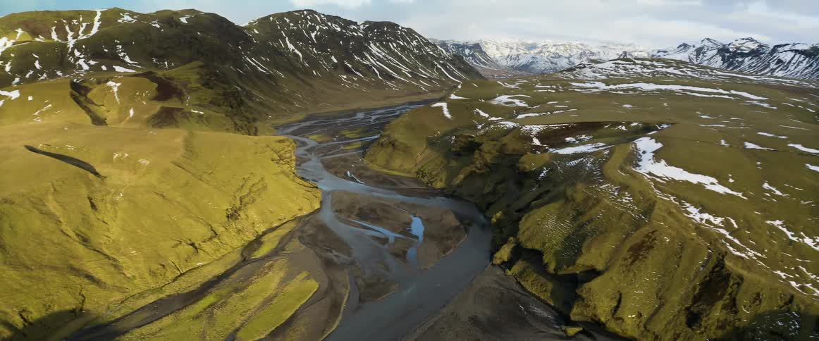 Aerial view of a river flowing through a valley in the mountains
