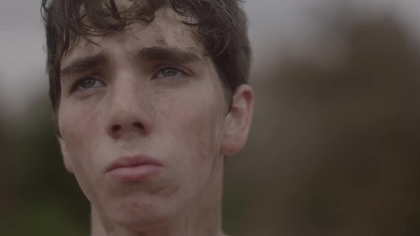 A man is staring forward in a windy area