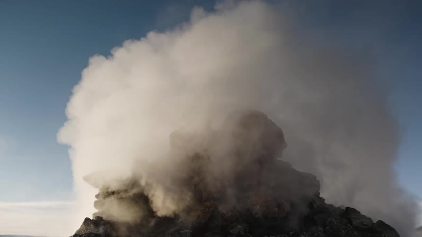 Steam rising from rocky geyser