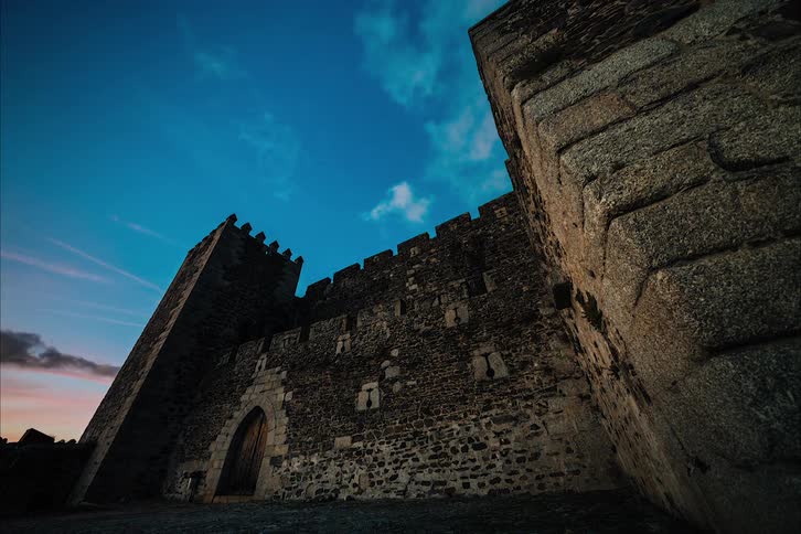 Clouds floating over an old castle at sunset