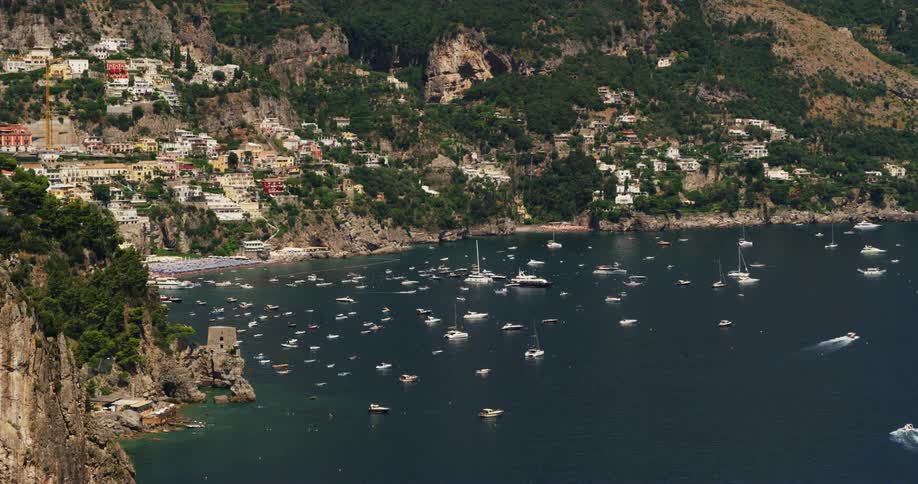 Boats are anchored all over the shore of the town