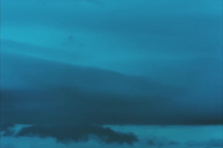 Smoke or dust slowly billows upwards and passes through the upper part of the shot