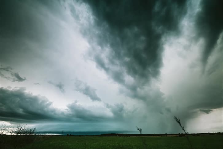 Storm clouds and lightning over a field in summer
