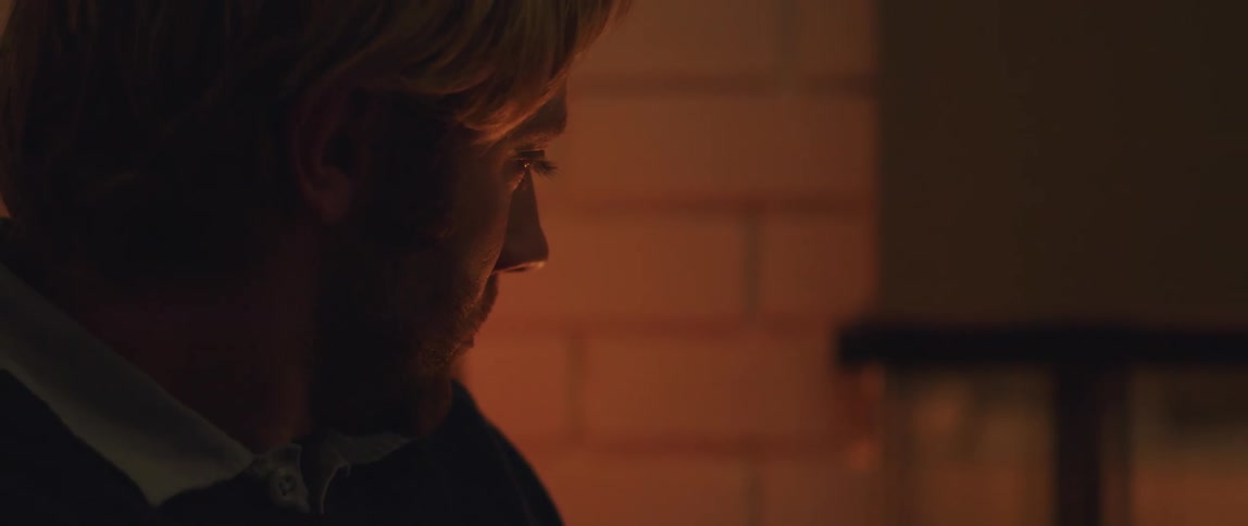 Man looks into the distance of an interior room
