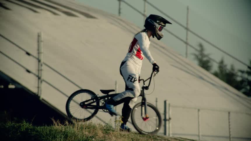 Woman on bmx turns and rides away