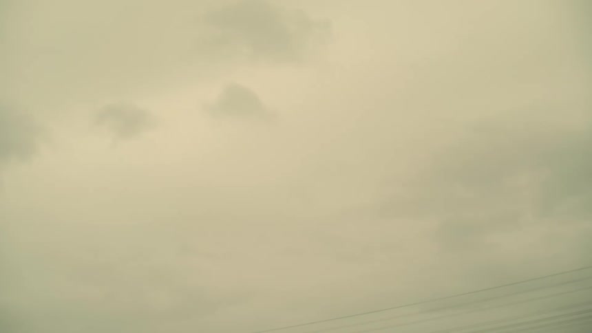 A person jumping on a motocross bicycle on an overcast day