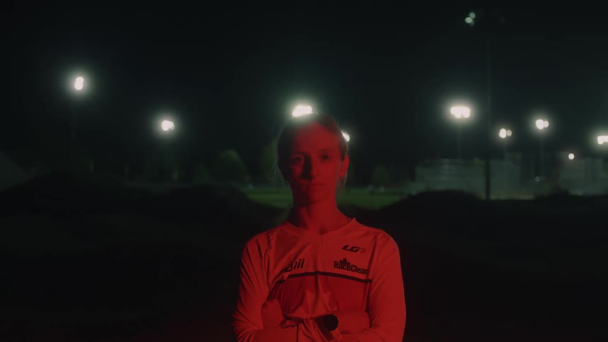 Young girl with folded arms stares at the camera