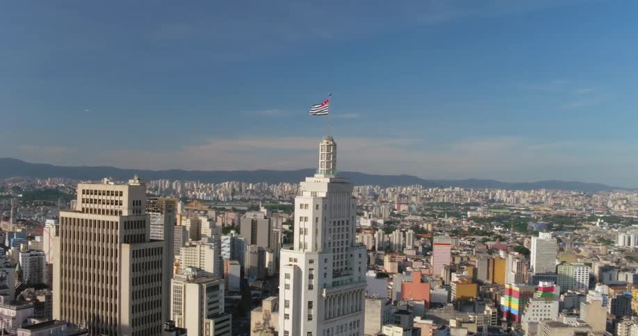 A flag is blowing on the top of the building