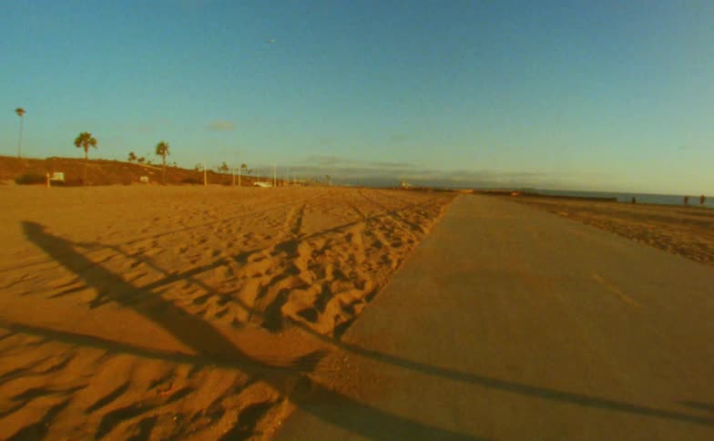 A shadow is moving on a path at the beach
