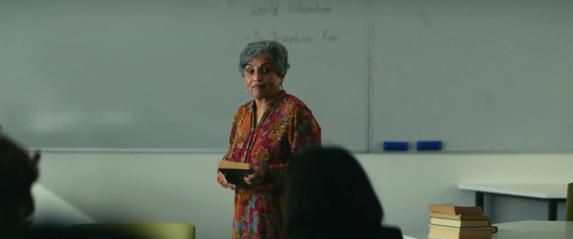 University teacher giving a lecture in front of students sitting on in a classroom