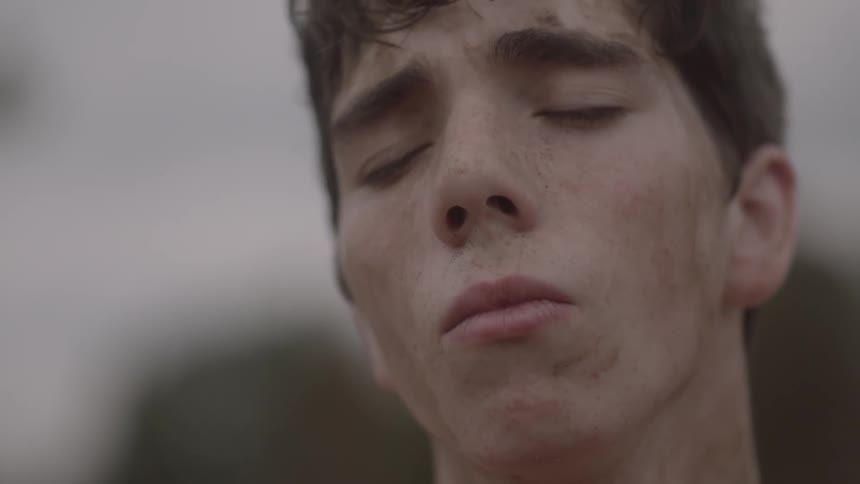 A man is looking forward before closing his eyes