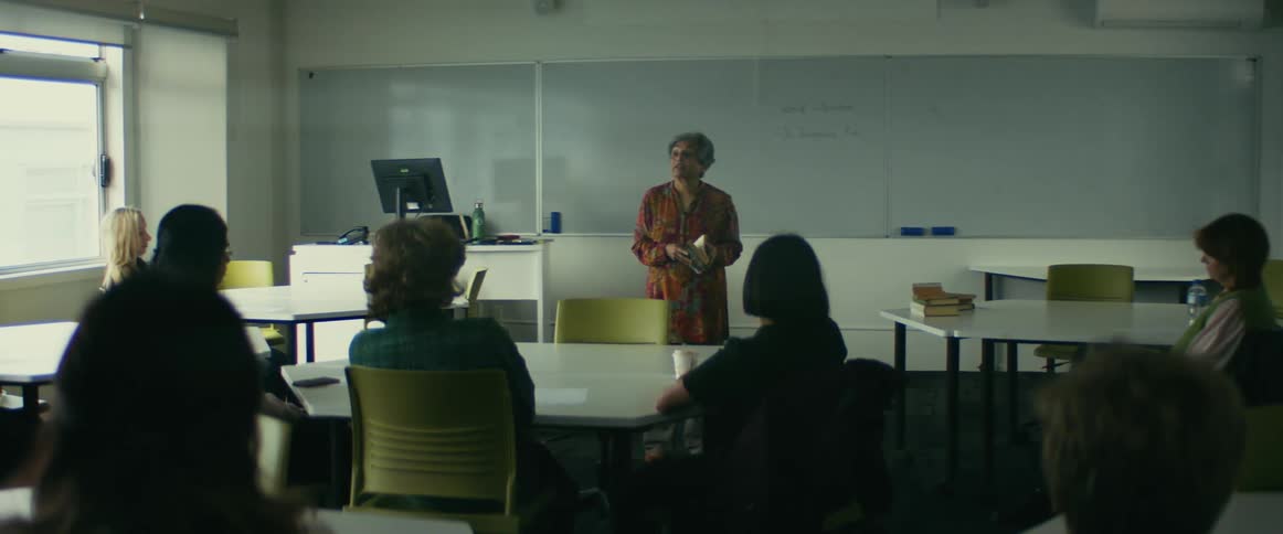 A teacher teaches in a classroom with 7 students sitting at desks